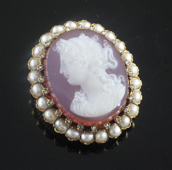 A late 19th/early 20th century French 18ct gold, diamond and split pearl set oval hardstone cameo brooch, 43mm.